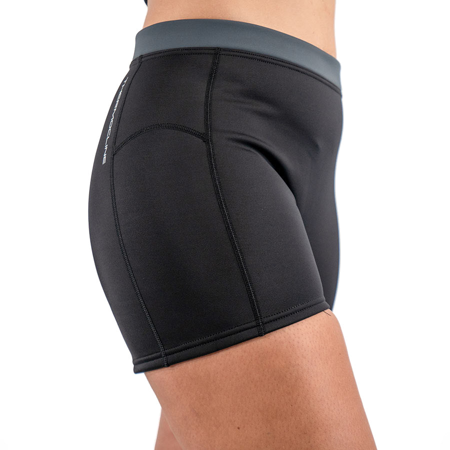 Women's Fourth Element Thermocline shorts in black with a grey waistband, seen from the side