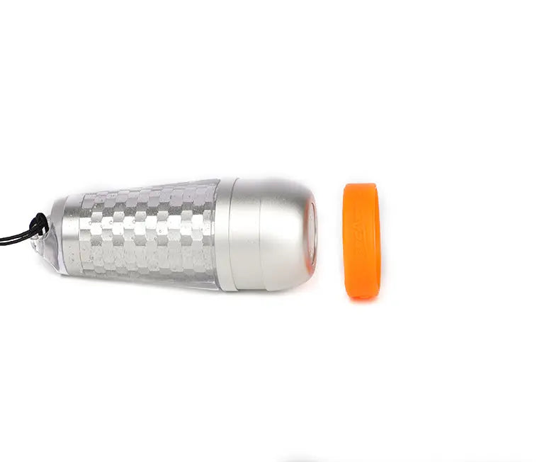 OrcaTorch SD03 beacon lying flat, showing the translucent shell and orange ring