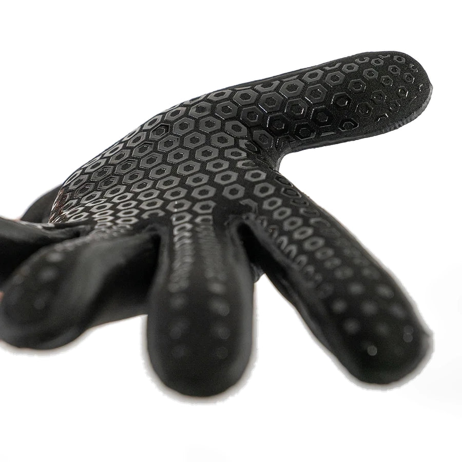 Black Fourth Element 5mm Hydrolock neoprene glove held open to show the hexagonal grip pattern across the palm and fingers