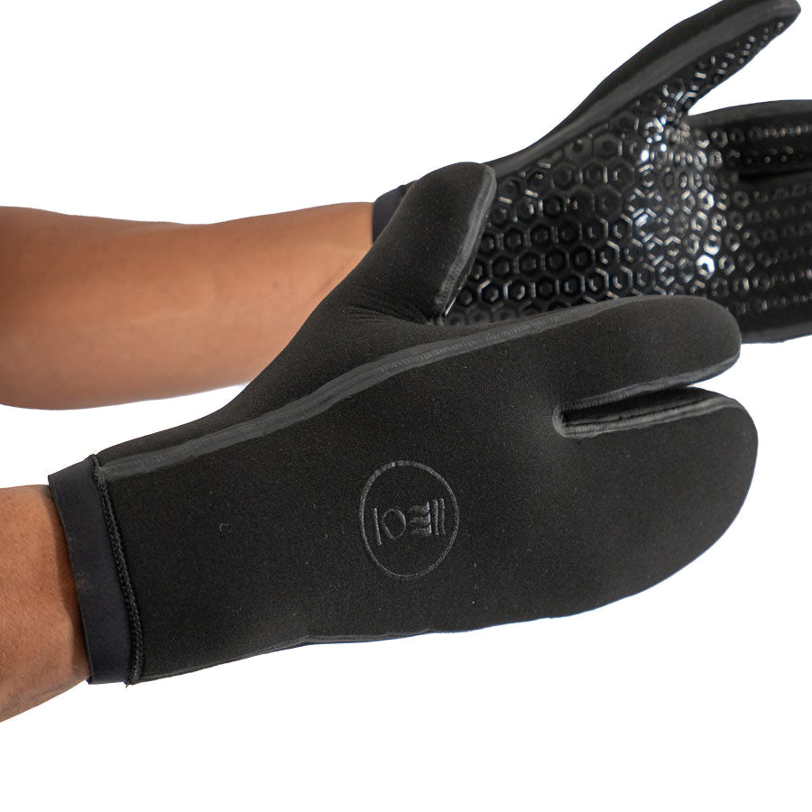 Pair of black Fourth Element 7mm Hydrolock three-finger dive mitts worn on the hands
