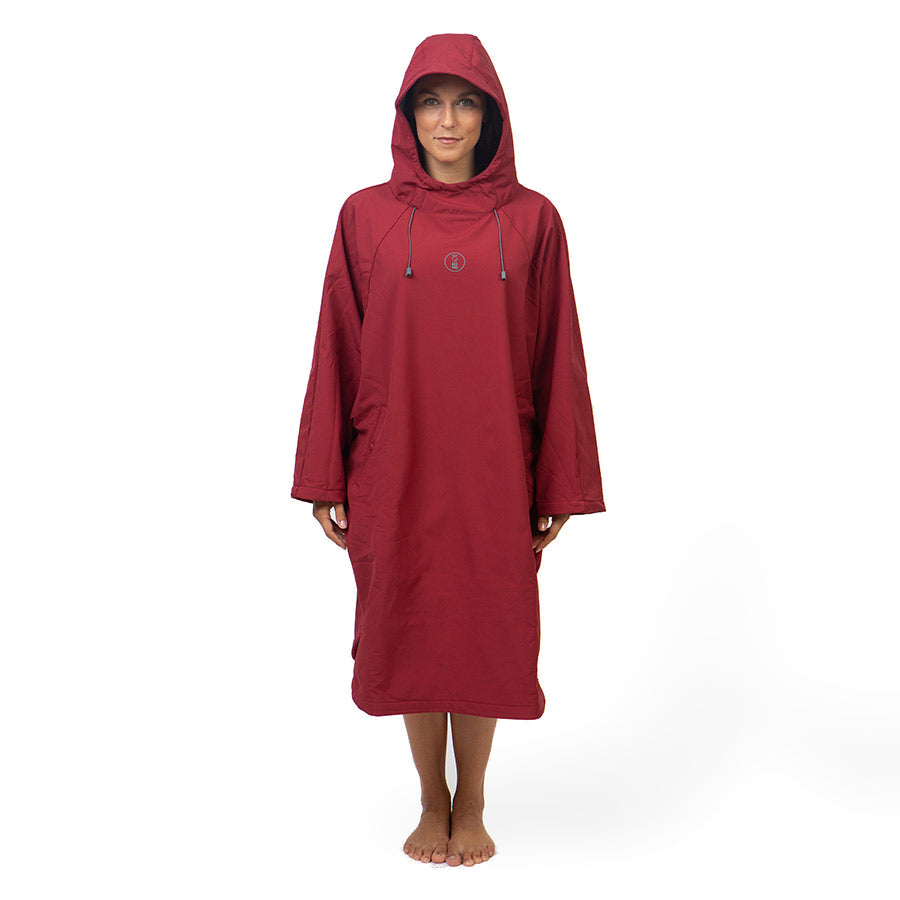 Fourth Element Storm poncho in burgundy worn front on with the hood down