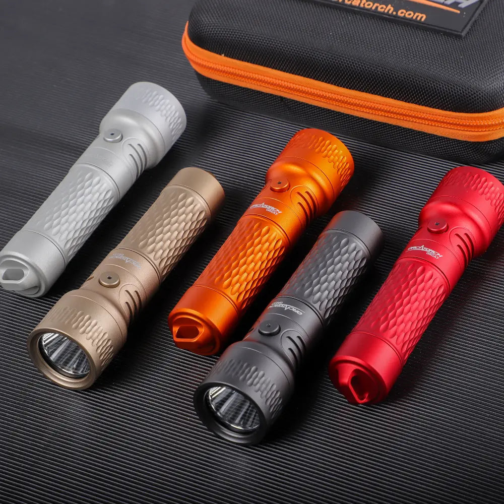 OrcaTorch ORCA7 backup dive lights laid on a mat beside the carry case, showing the finish range