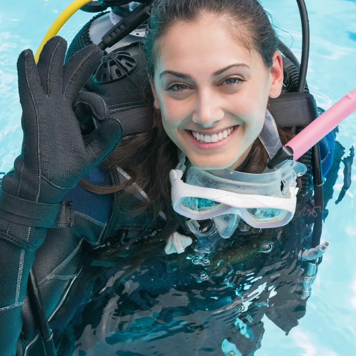 A diver at the surface in full kit giving the OK signal