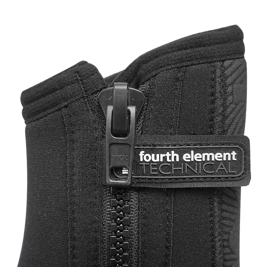 Pair of black Fourth Element Amphibian 6.5mm dive boots worn, showing the side zip and moulded rubber sole
