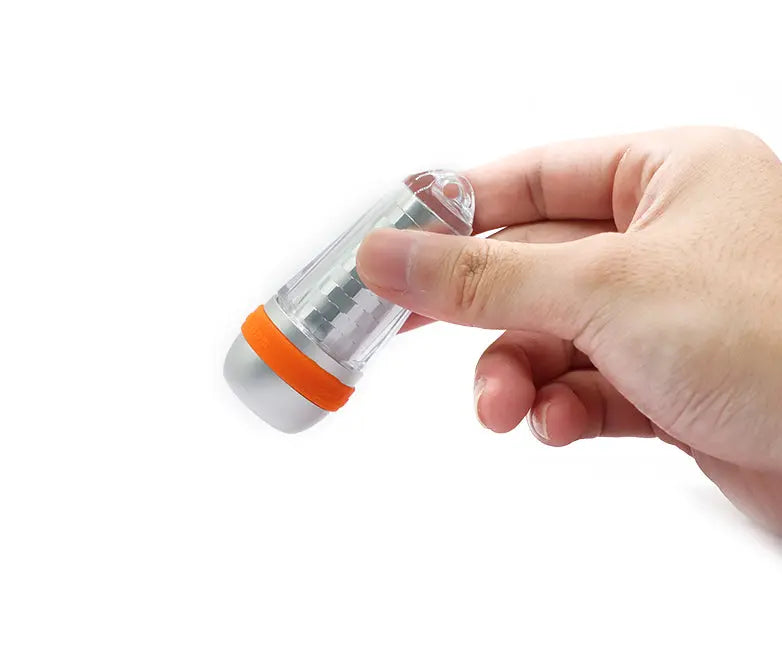 OrcaTorch SD03 beacon held in a hand, showing its size