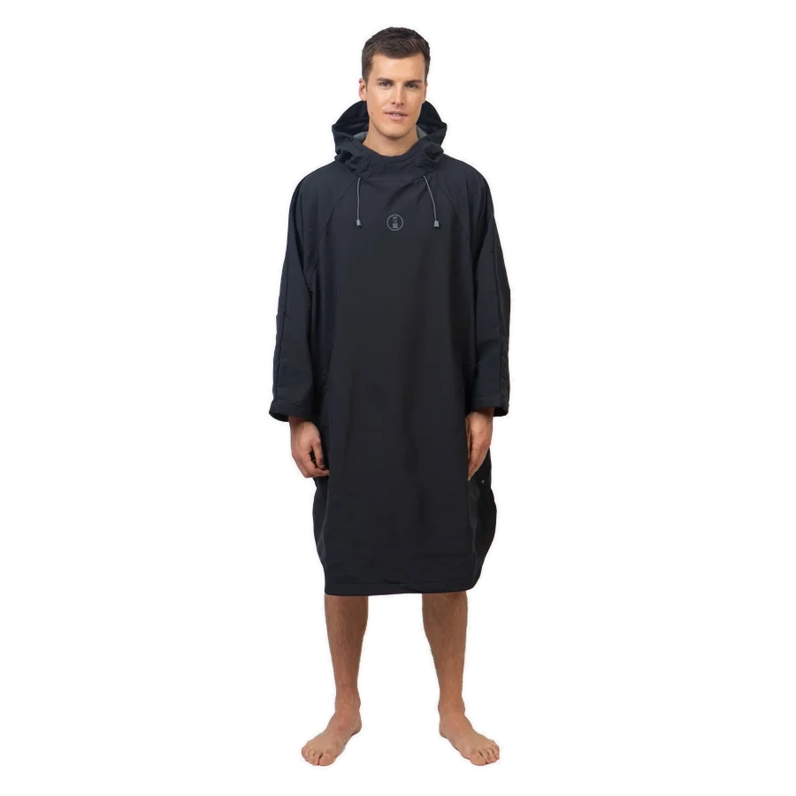 Fourth Element Storm poncho in black worn front on with the hood down