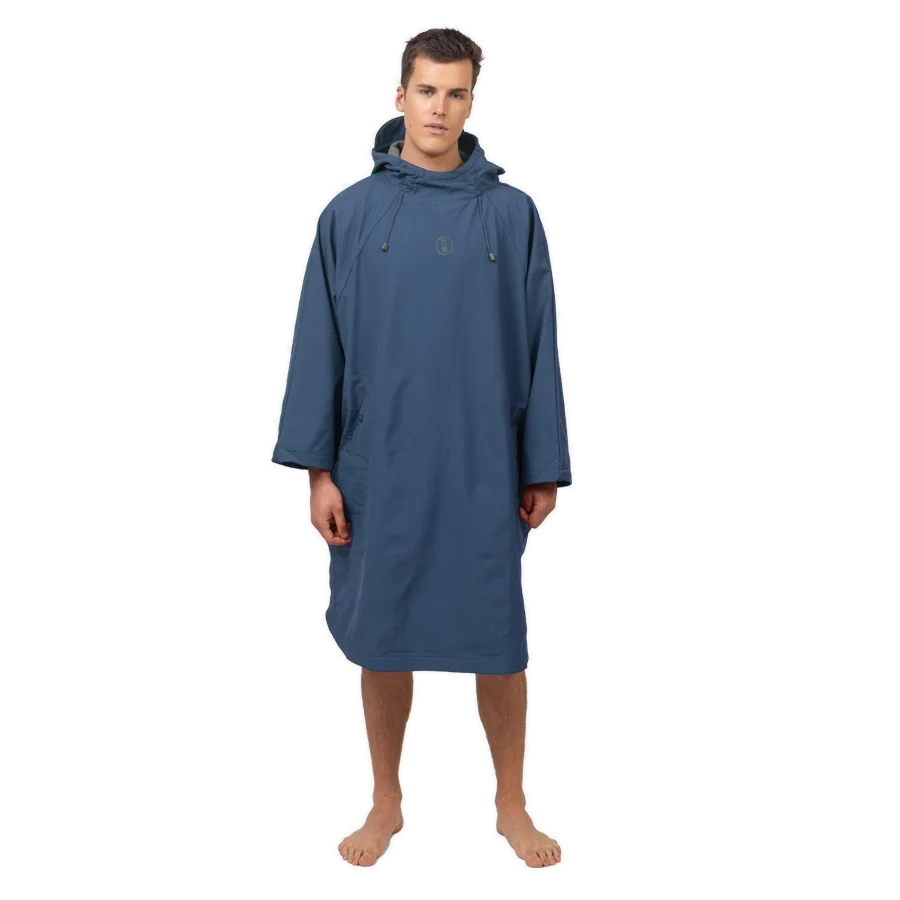 Fourth Element Storm poncho in blue worn front on with the hood down