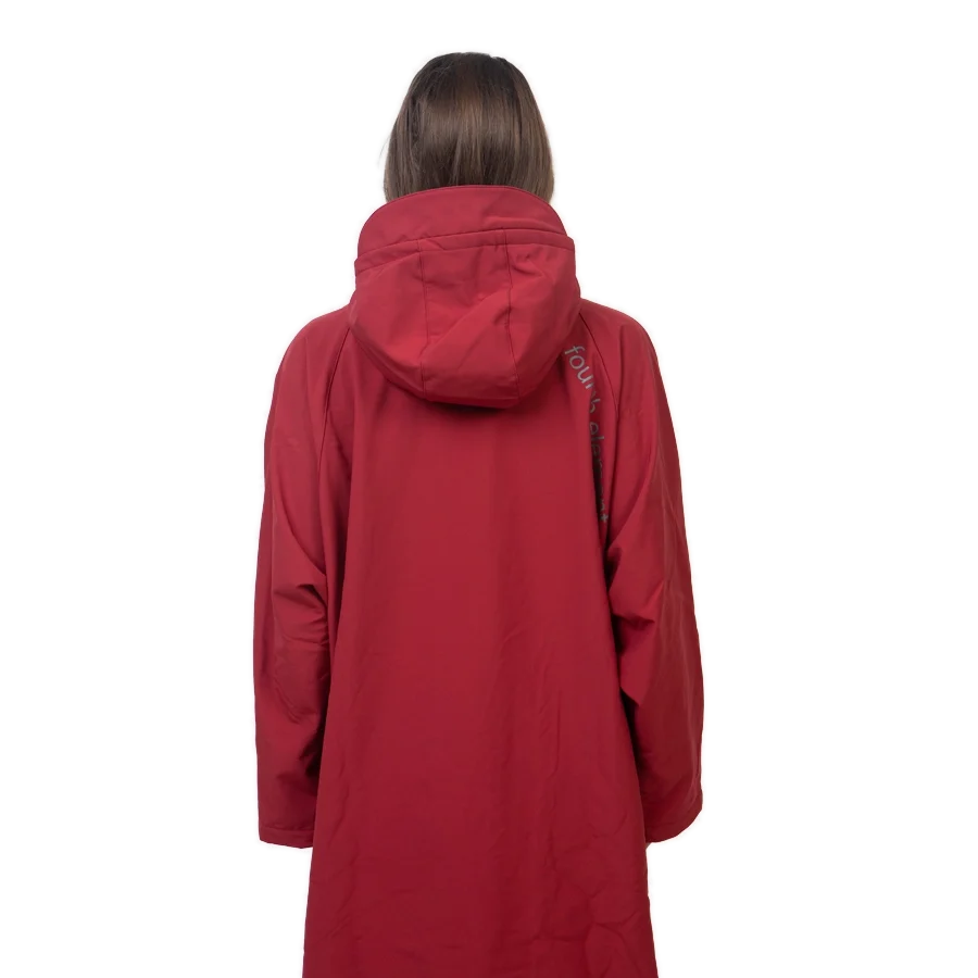 Fourth Element Storm poncho in burgundy worn front on with the hood down