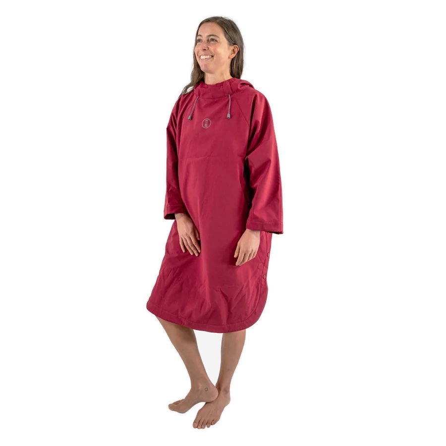 Fourth Element Storm poncho in burgundy worn front on with the hood down