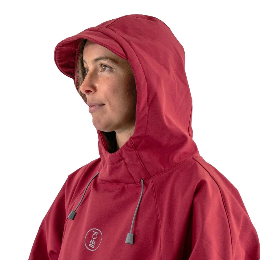 Fourth Element Storm poncho in burgundy worn front on with the hood down