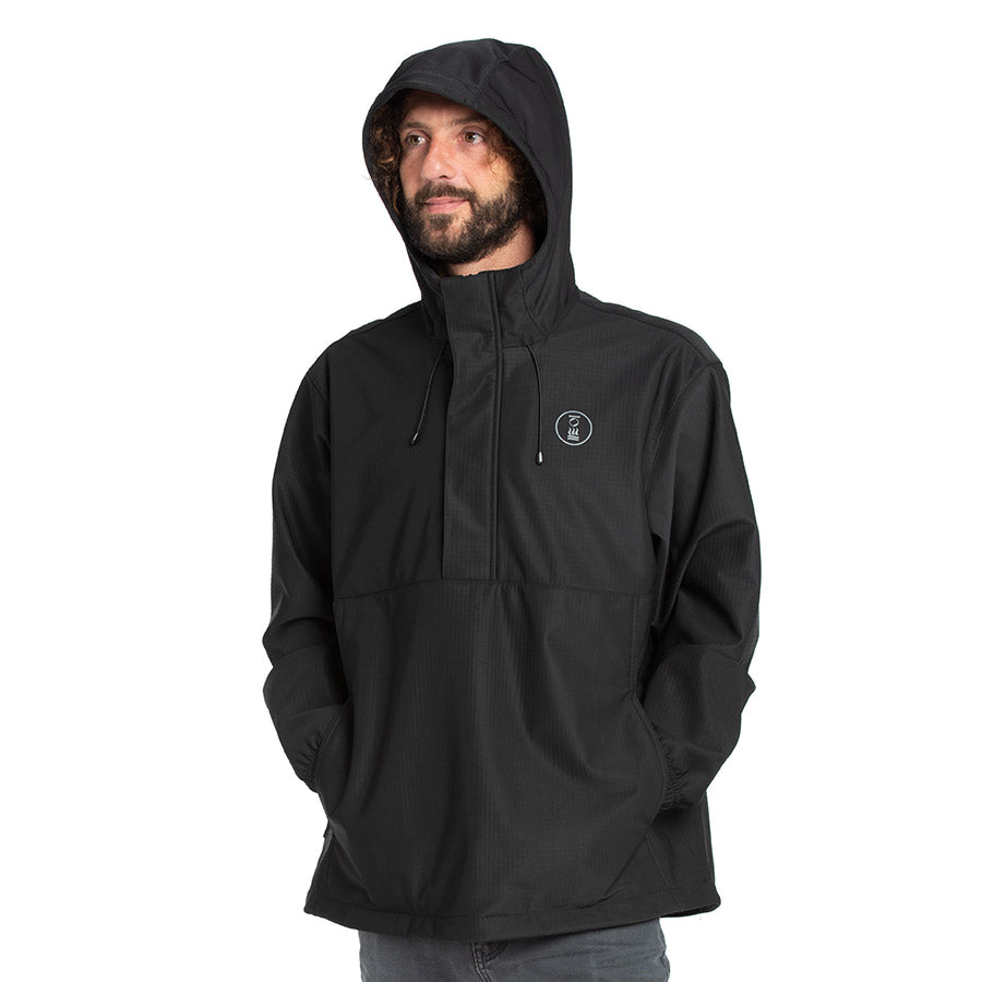 Men's Fourth Element windbreaker smock in black worn front on, showing the half zip and kangaroo pocket