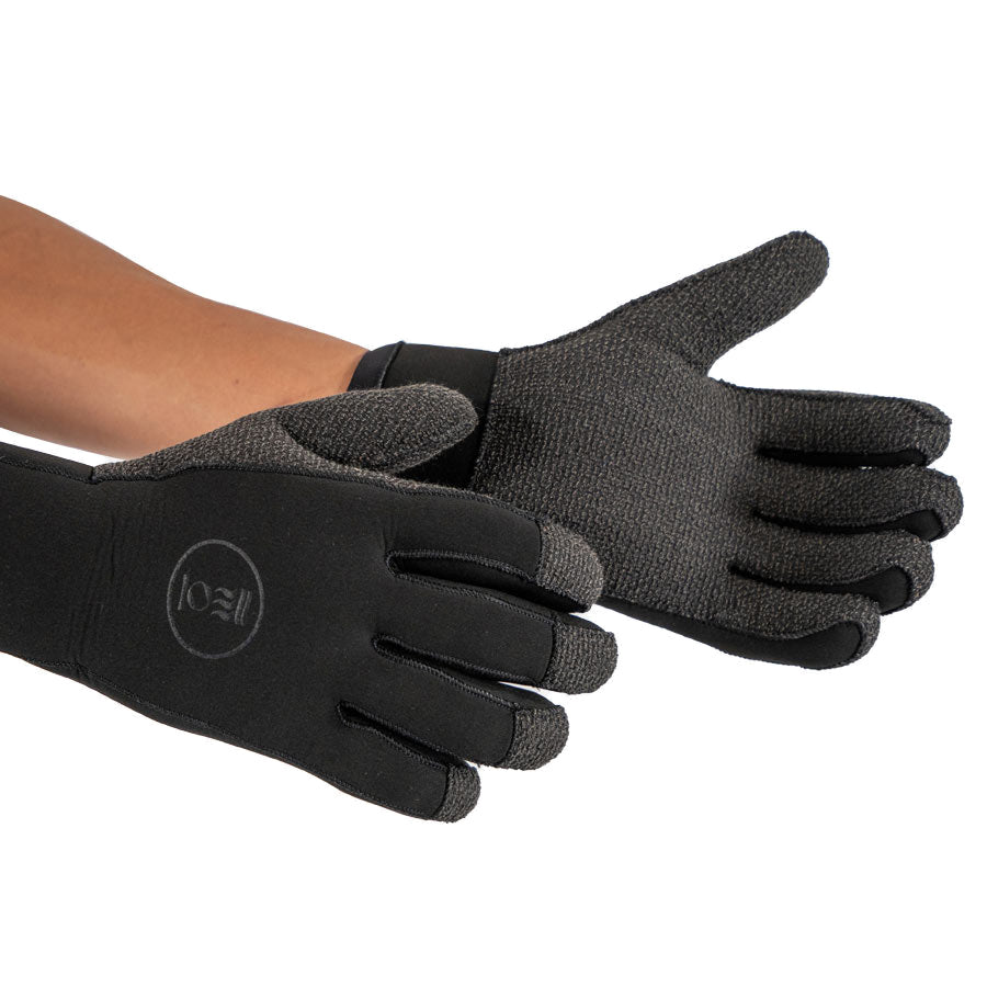 Pair of black Fourth Element 5mm Kevlar Hydrolock dive gloves worn on the hands, one open to show the reinforced palm