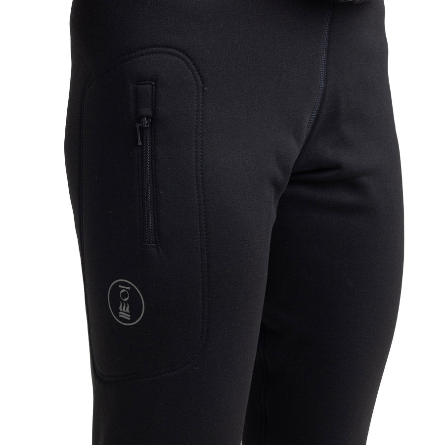 Women's Fourth Element Arctic leggings in black worn front on with the drawcord waist and stirrup feet