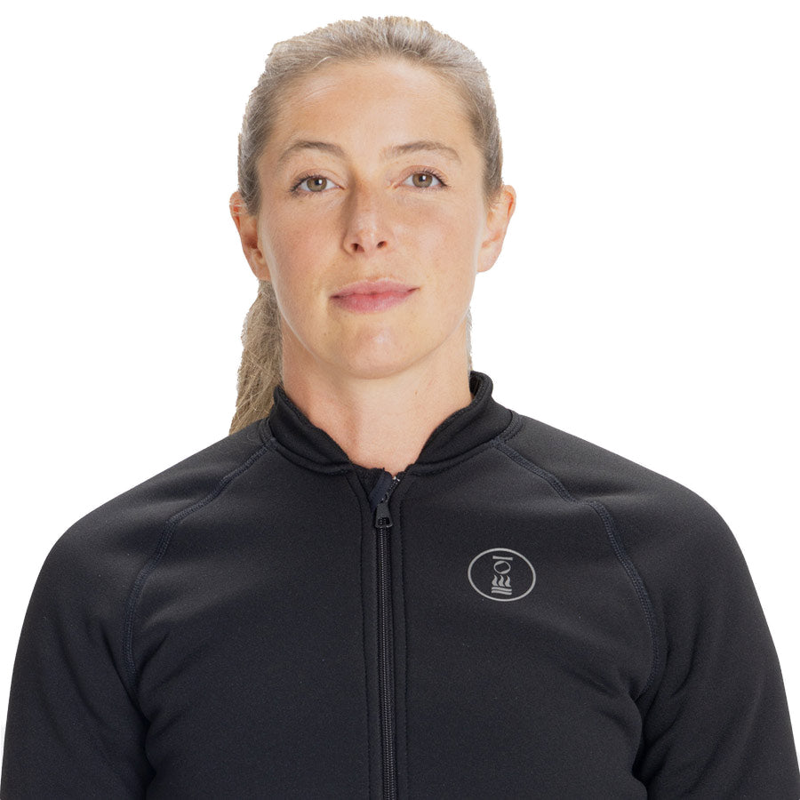 Women's Fourth Element Arctic top in black worn front on with hands in the side pockets