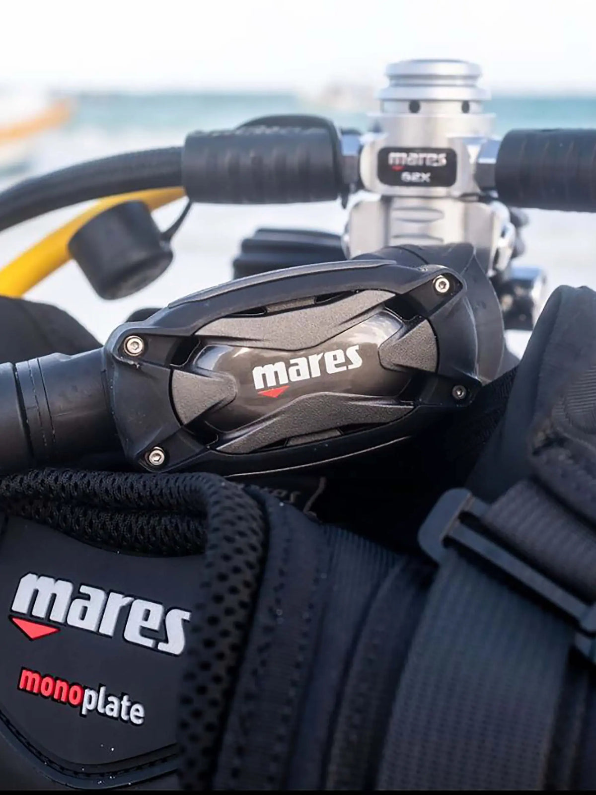 Mares SXS second stage clipped to a BCD chest strap beside the first stage on a cylinder