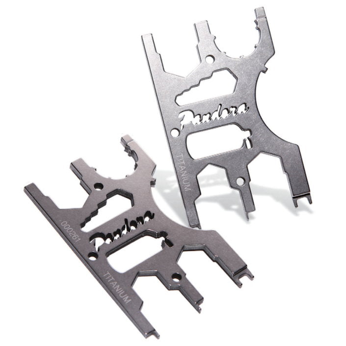 Two Pandora Lab titanium multi-tools laid across each other, showing the spanner cut-outs