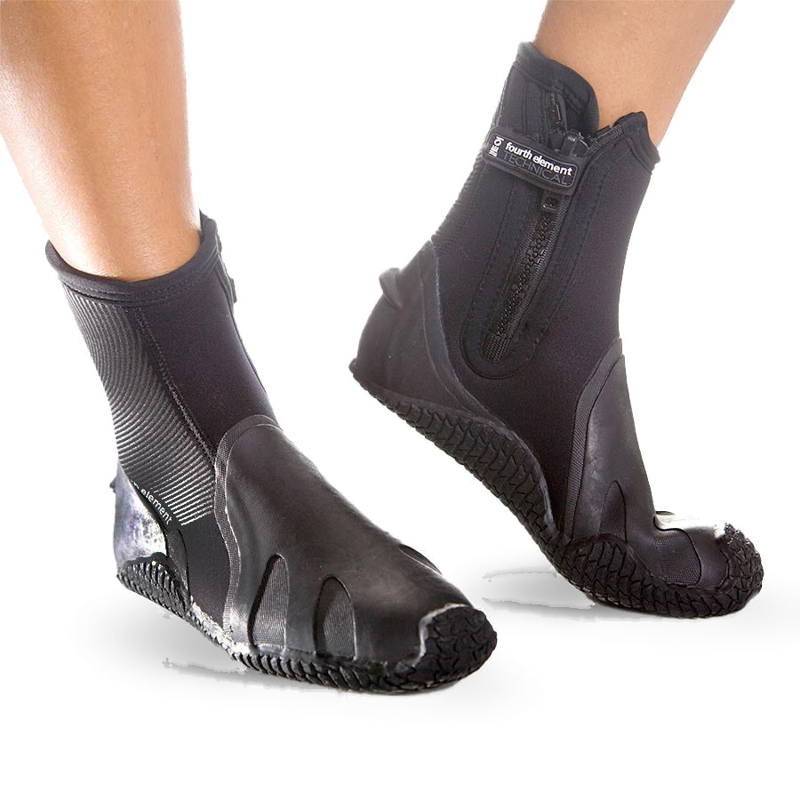 Pair of black Fourth Element Pelagic 6.5mm dive boots worn, showing the moulded sole wrap