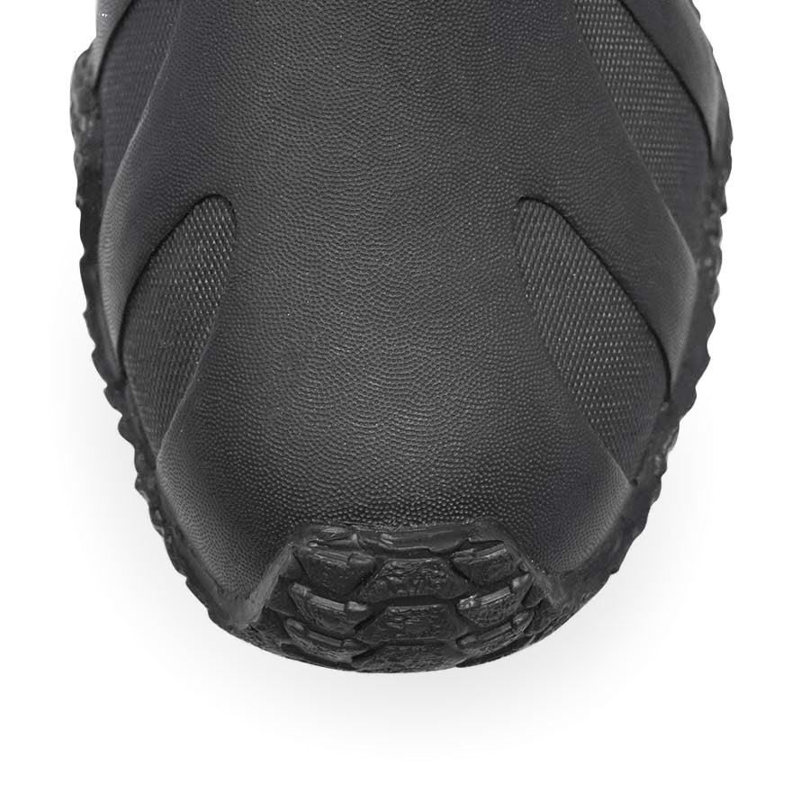 Pair of black Fourth Element Pelagic 6.5mm dive boots worn, showing the moulded sole wrap