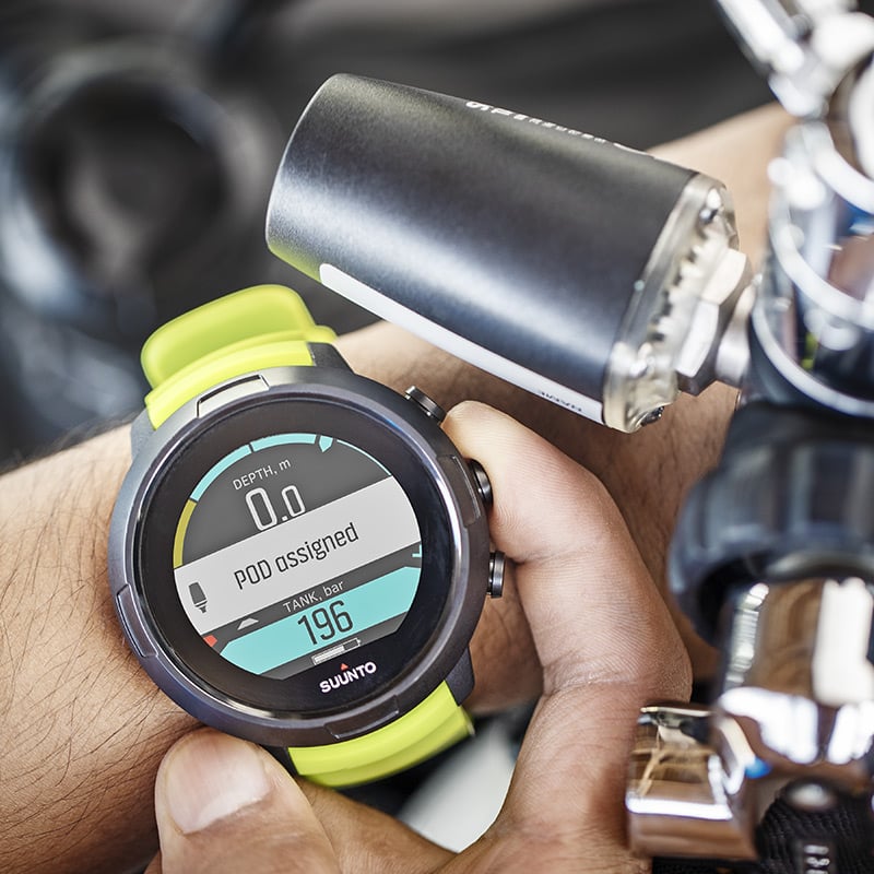 Suunto Tank POD standing upright, showing the serial label panel and the high-pressure thread