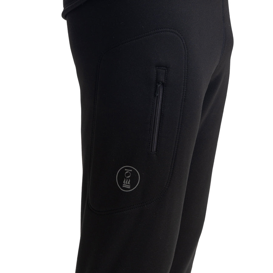 Men's Fourth Element Arctic leggings in black worn front on with the drawcord waist and stirrup feet