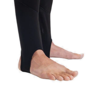 Men's Fourth Element Arctic leggings in black worn front on with the drawcord waist and stirrup feet