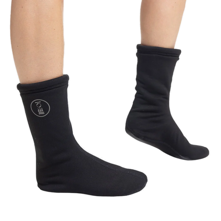 Pair of black Fourth Element Arctic drysuit socks worn on the feet