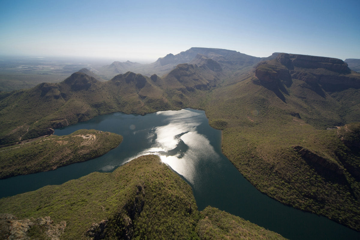 Aerial view of the Blyde River Canyon dam, a freshwater lake winding between escarpment peaks, Mpumalanga, South Africa