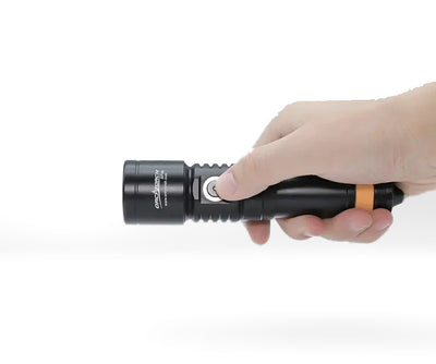 OrcaTorch D710 held in a hand, showing its size