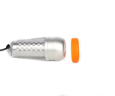 OrcaTorch SD03 beacon lying flat, showing the translucent shell and orange ring