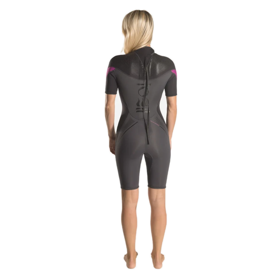 Women's Fourth Element Xenos 3mm shortie in black with fuchsia shoulder panels, worn front on