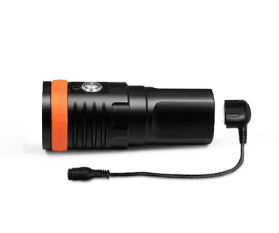 OrcaTorch D910V video light with its magnetic charging cable attached