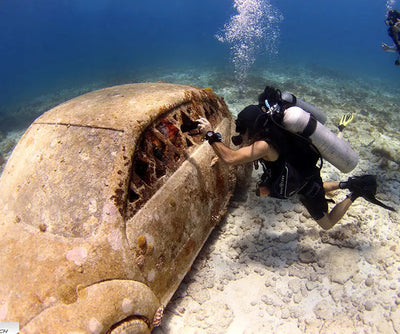 Diver inspecting a wreck with an OrcaTorch D860