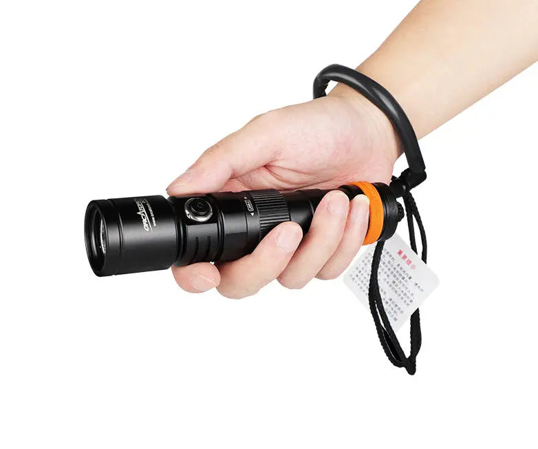 OrcaTorch DC710 held in a hand with the lanyard fitted