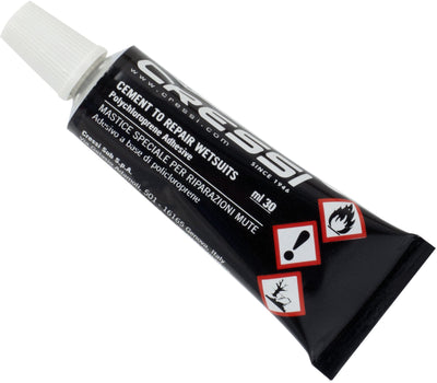Cressi wetsuit repair cement tube laid on its side with the hazard symbols facing out