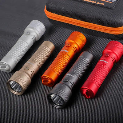 OrcaTorch ORCA7 backup dive lights laid on a mat beside the carry case, showing the finish range
