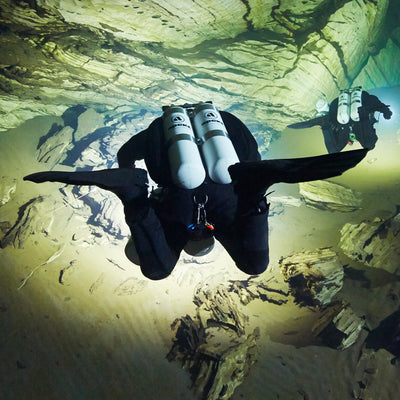 Diver finning through a cavern in Apeks RK3 HD fins