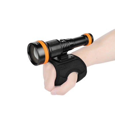 OrcaTorch ZD710 MK2 held in a hand on the WS02 wrist strap