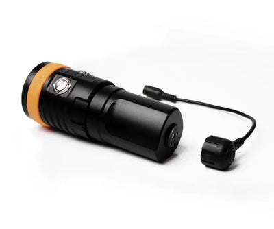 OrcaTorch D900V video light with its magnetic charging cable attached