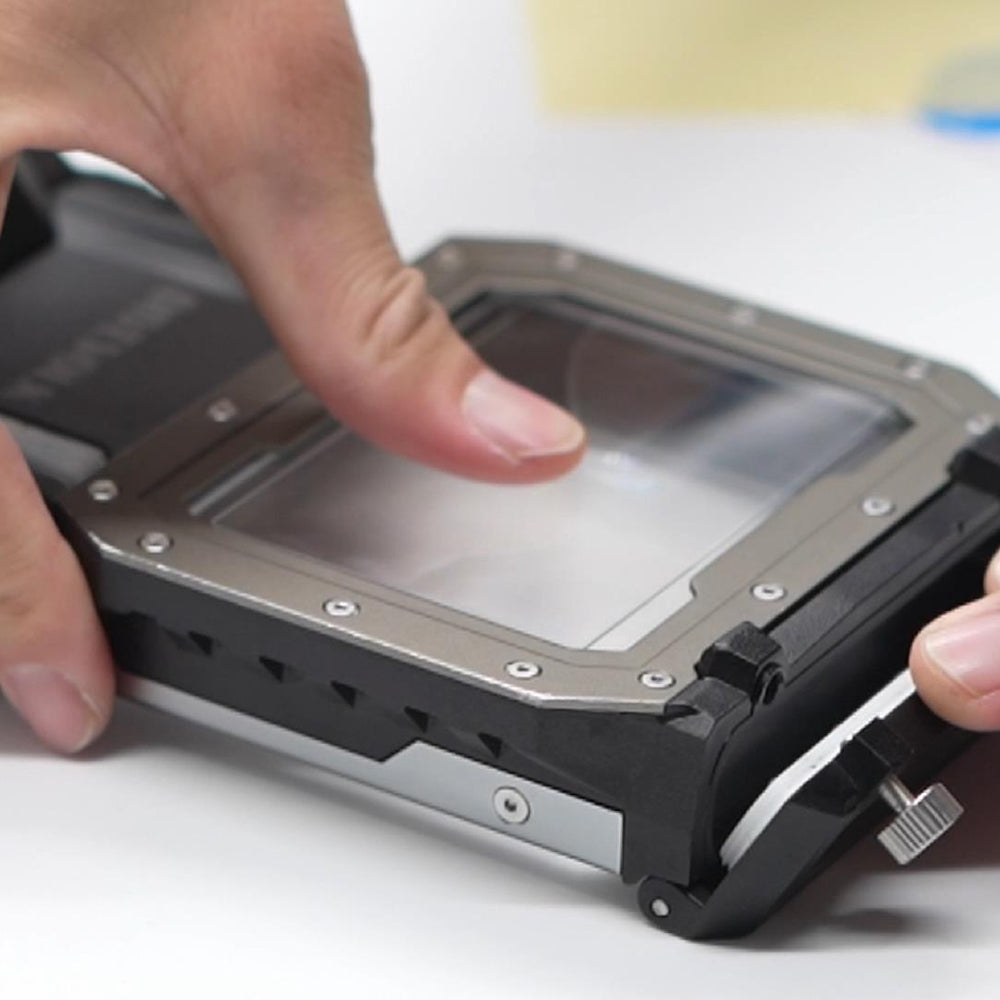 Glass protective film being pressed onto a Divevolk SeaTouch 4 Max housing
