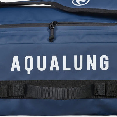 Close view of the Aqualung name printed on the navy panel of an Explorer 45L dive bag beside a zipped pocket