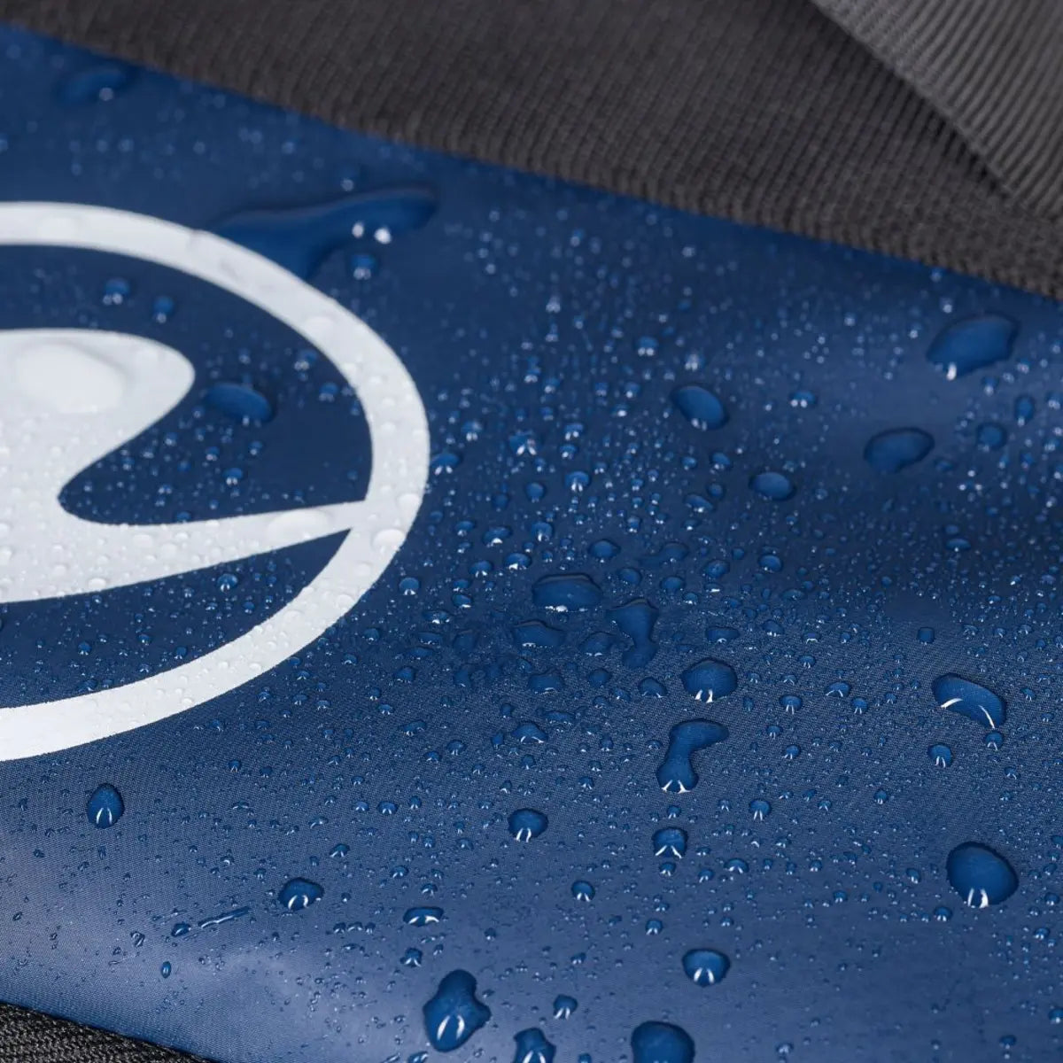 Water beading on the water-repellent navy outer fabric of an Aqua Lung Explorer 45L dive bag