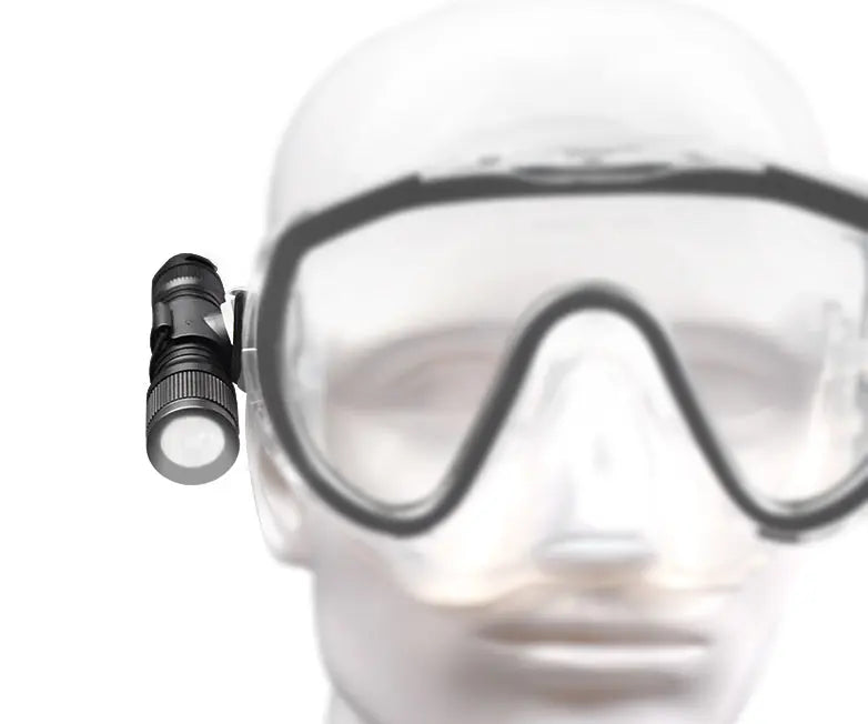 OrcaTorch D560 clipped to a dive mask strap on its mask mount