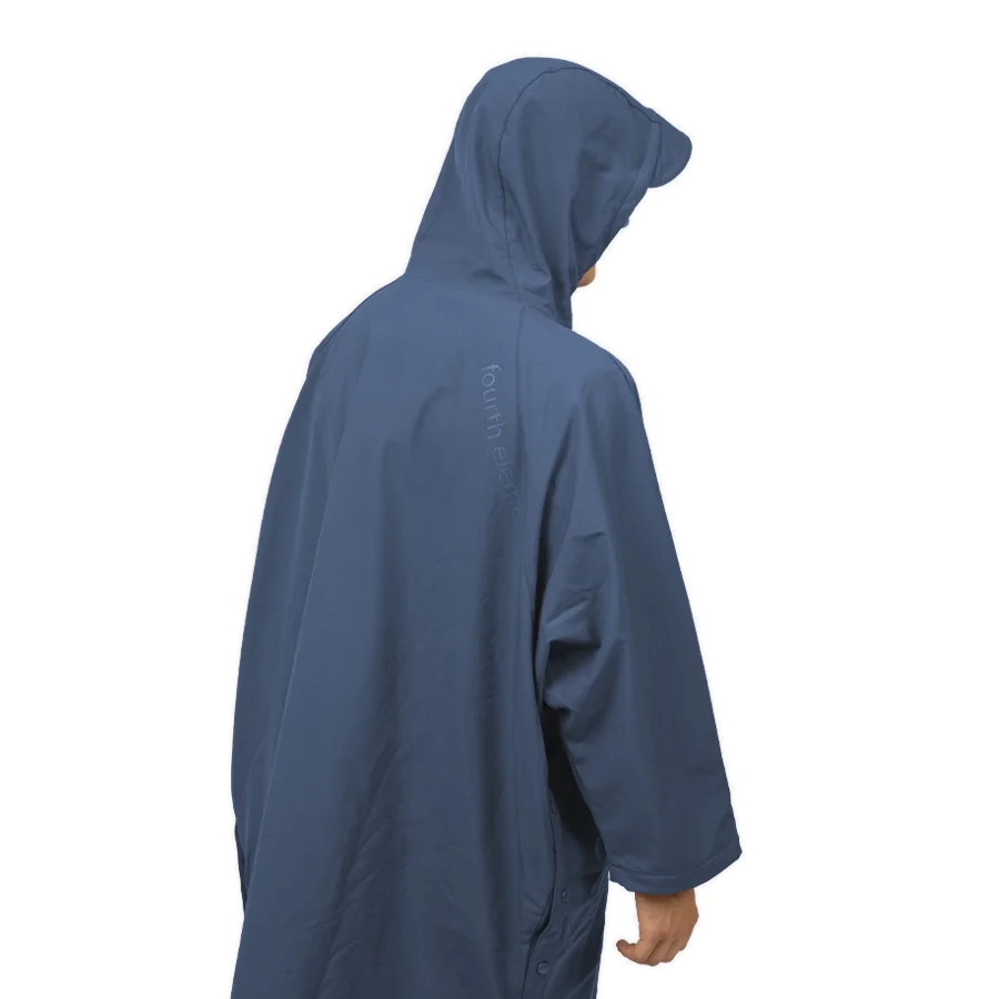 Fourth Element Storm poncho in blue worn front on with the hood down