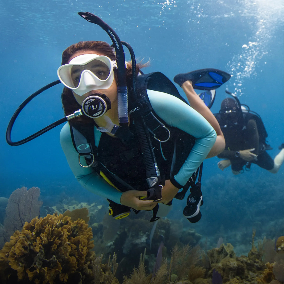 Open water diver swimming over a reef