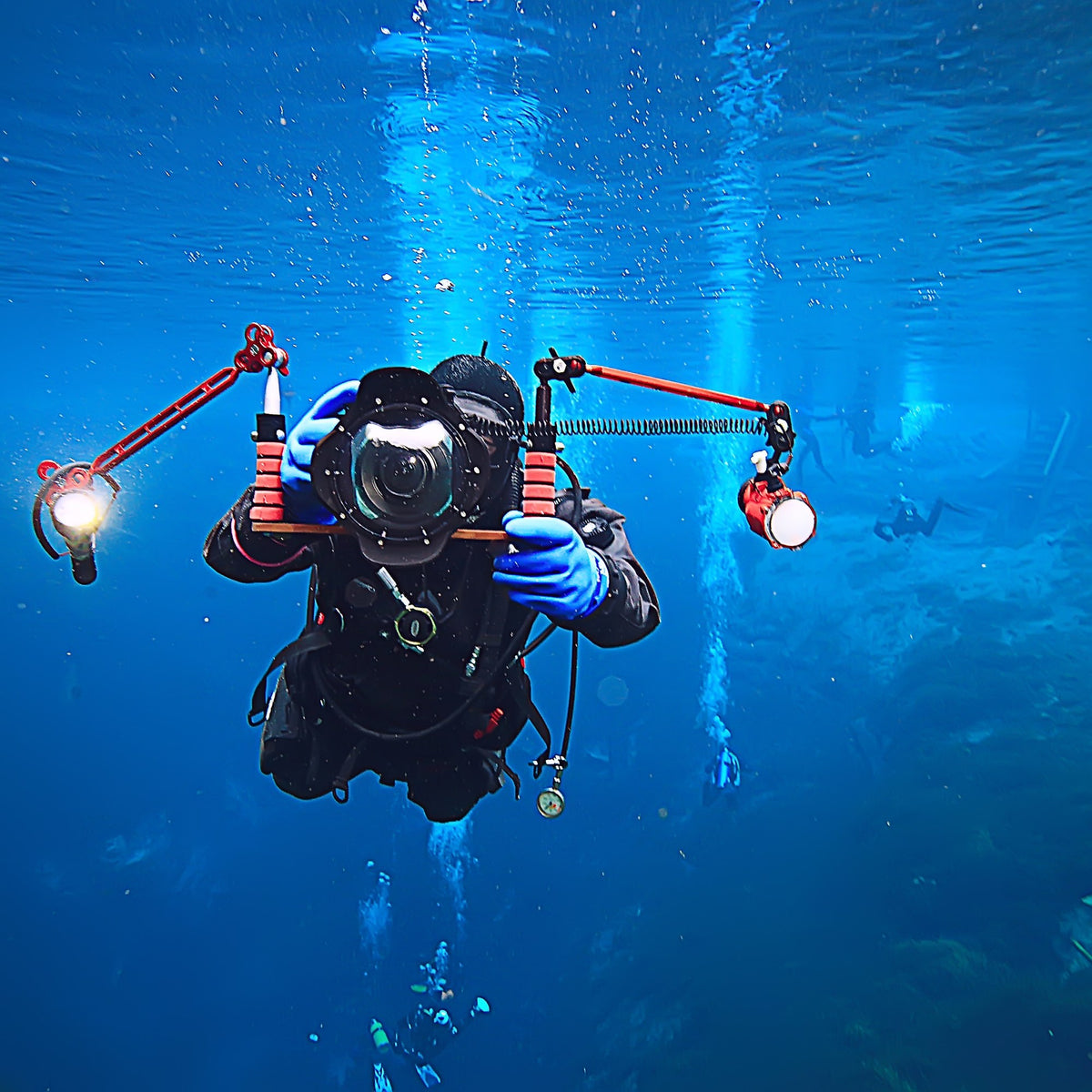 Diver head-on with an underwater camera housing and twin strobes