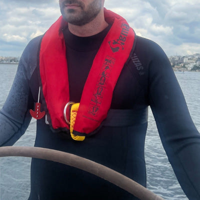 Skipper wearing the red Lalizas Sigma inflatable lifejacket at sea