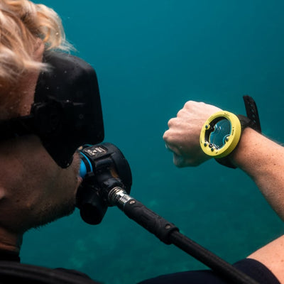 Diver underwater wearing a lemon yellow Suunto Zoop Novo