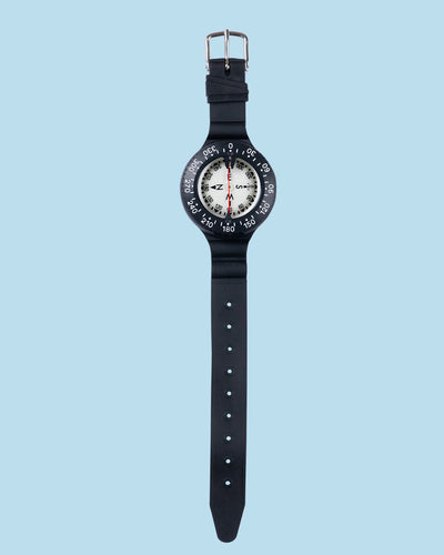 Termo Industria wrist compass with the full black buckle strap laid out