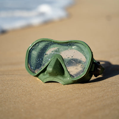 Khaki Tusa Zensee mask resting on beach sand