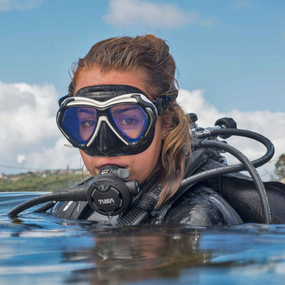 Diver at the surface wearing a black Tusa Paragon mask